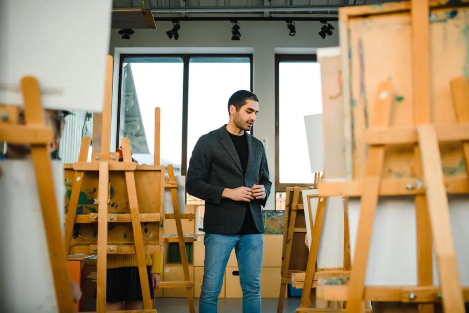 Art student among easels and canvases in a studio