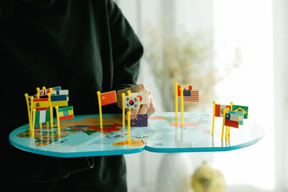 Miniature flags representing different countries pinned on a world map
